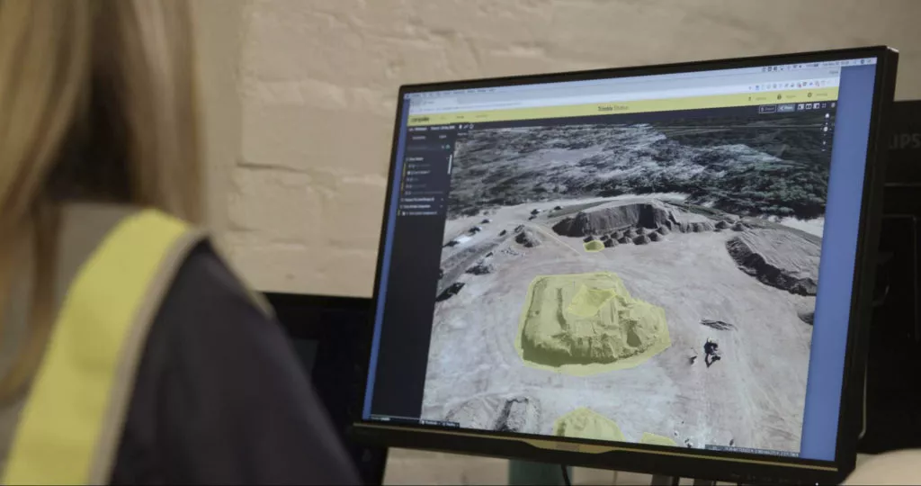 Person looking at screen platform stockpile measurement