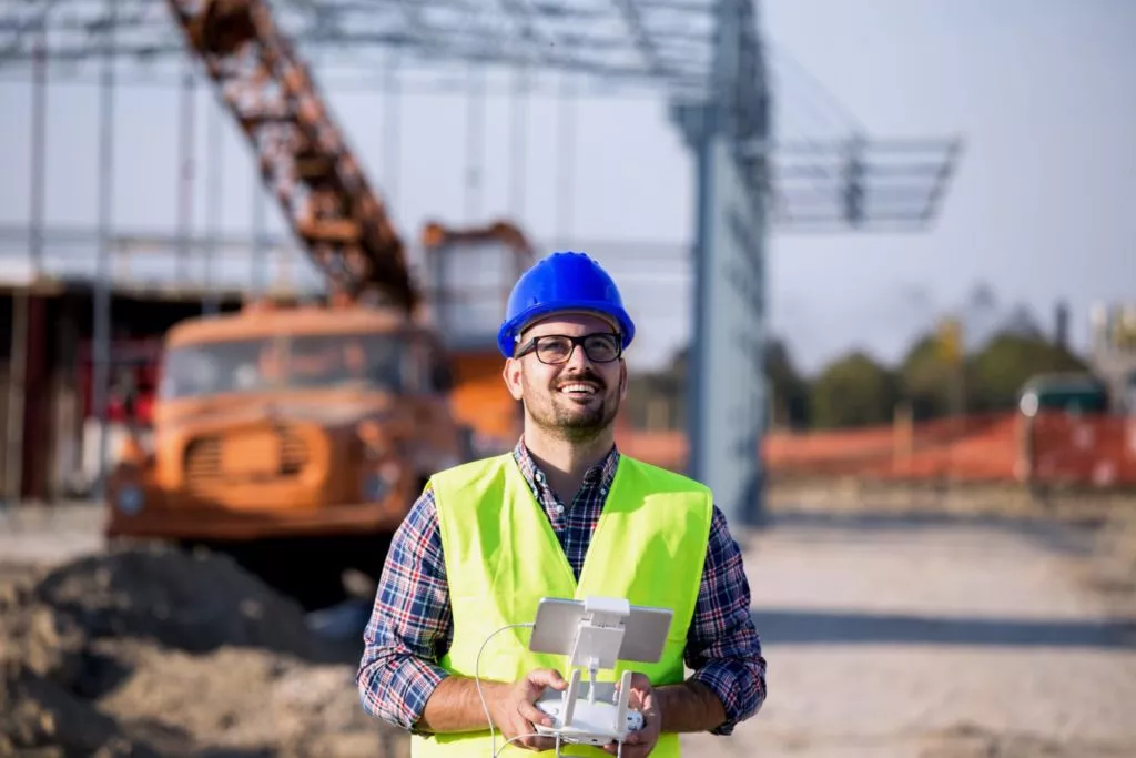 Person flying drone on site controller