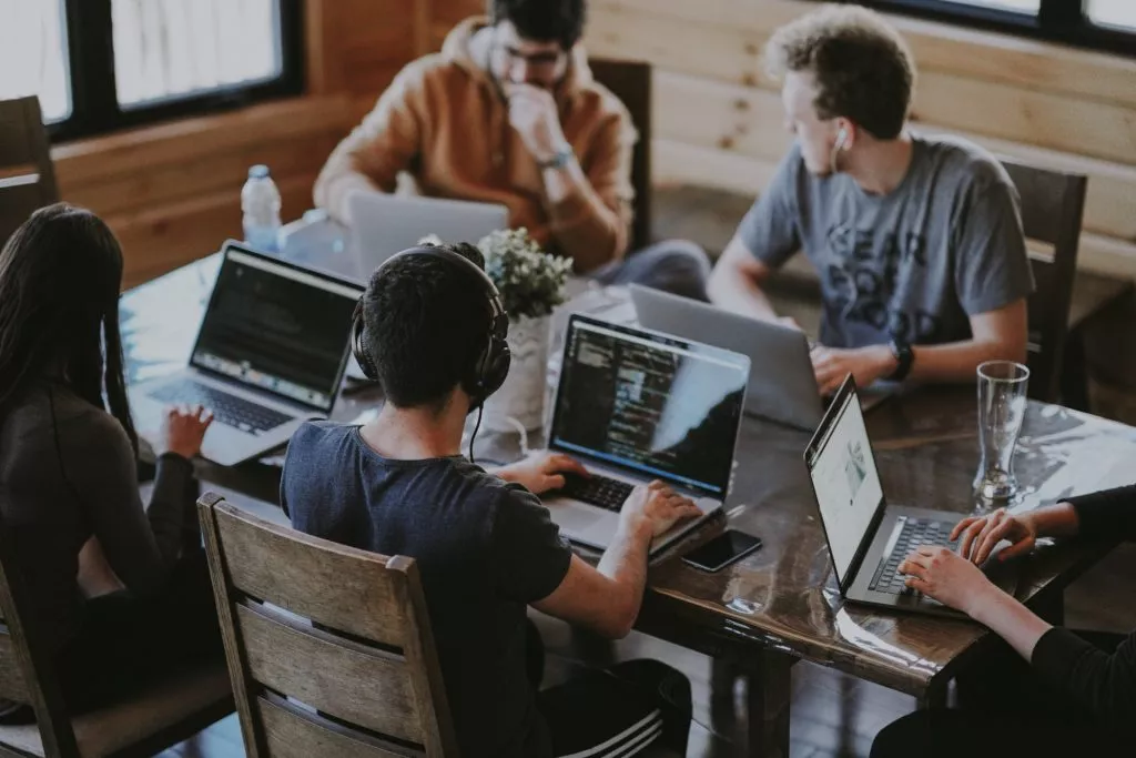 people working on laptops at table