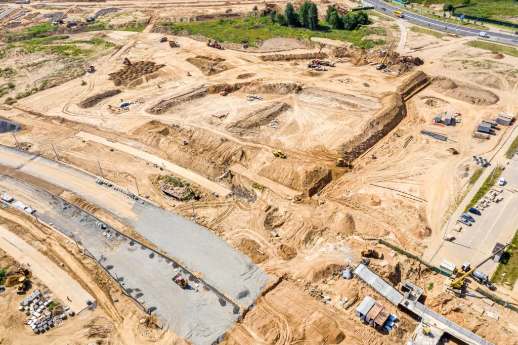 construction of new road, aerial top view. industrial machinery working at construction site